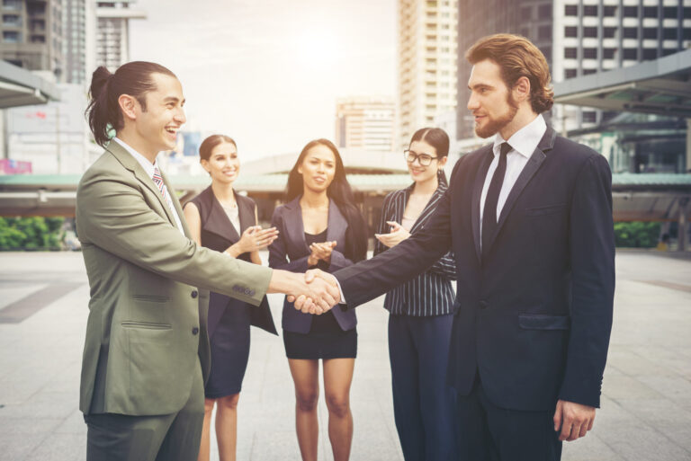 Happy business people shaking hands. Business success
